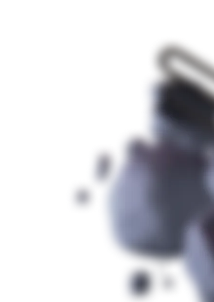 Blurred close-up of a round, multi-lobed, gray object with a dark cap or top on the right side.